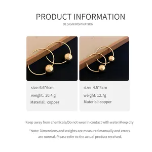Detailed view of minimalist gold copper hoop earrings with metallic ball accents.