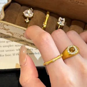 Close-up of vintage brushed bamboo gold rings with zircons on a hand detail view