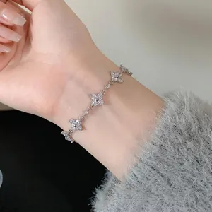 Elegant silver flower bracelet with shimmering cubic zirconia stones worn on a delicate wrist