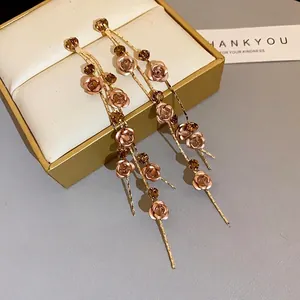 Elegant long tassel earrings with rose flower and rhinestone details in vintage gold