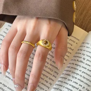 Close-up of vintage gold bamboo joint rings with zircon decoration on a hand