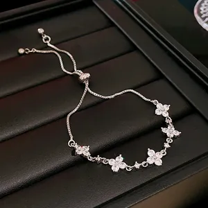 Close-up of elegant silver flower bracelet with sparkling zircon and adjustable slider.
