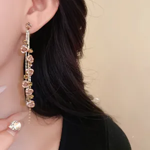 Detailed macro shot of elegant rose flower tassel earrings featuring sparkling rhinestone accents