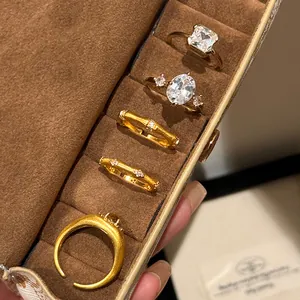 Detail of vintage brushed gold bamboo ring set with sparkling zircons in a jewelry box