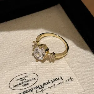 Close-up of a vintage brushed gold ring with a large brilliant zirconia center stone