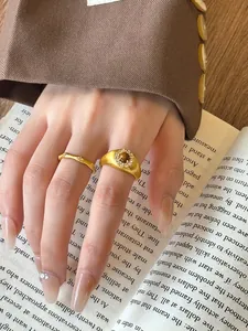 Detailed macro view of vintage gold-finished bamboo ring set with sparkling zircon stones