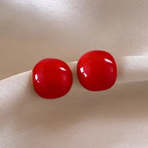 Elegant bright red round domed stud earrings with high-gloss finish and silver needles