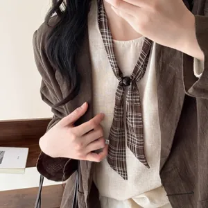 Elegant detail view of a vintage plaid neck scarf necklace with a stylish black bead fastener