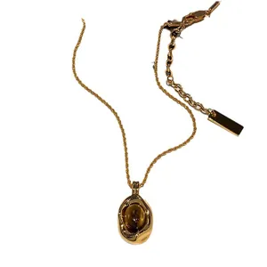 Elegant vintage gold plated necklace with faux tiger eye stone pendant and adjustable chain