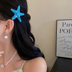 Elegant blue acrylic starfish hair clip perfect for a stylish seaside vacation hair look