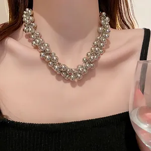 Elegant silver cluster ball necklace on a model featuring a shiny metallic finish