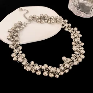 Detailed macro shot of chunky silver cluster bead choker necklace with high-shine metallic finish