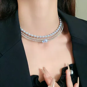 Close-up view of an elegant multi-layer pearl and zircon choker necklace on model