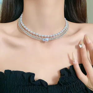 Close-up of elegant multi-layer artificial pearl and zircon choker necklace on model