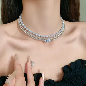 Close-up of multi-layer silver choker necklace with synthetic pearls and zircons