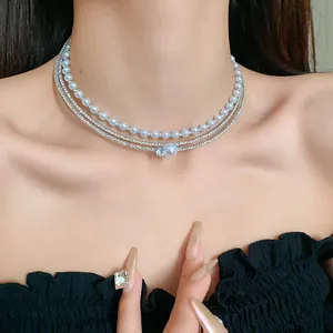 Elegant multi-layer choker necklace with faux pearls and sparkling zirconia details.