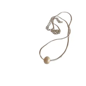 Elegant French style silver snake chain necklace with a single white pearl pendant