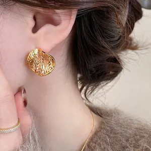 Minimalist 18k gold plated circular stud earrings with unique wrinkled texture design.