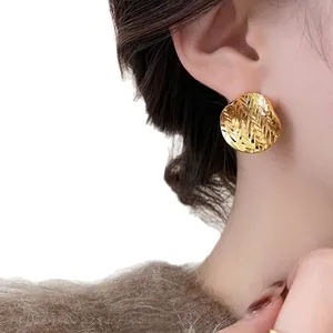 Minimalist 18k gold plated pleated round stud earrings for women on model