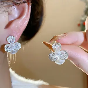 Elegant French silver needle flower stud earrings with zircon and pearls shown on ear