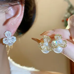 Detailed view of French-style zircon flower earrings with elegant white pearls for women