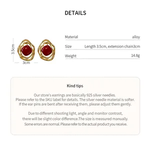 Detail view showing dimensions and materials of gold-tone irregular geometric earrings.
