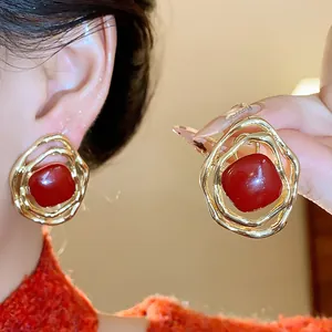 Elegant irregular gold ear clips with vibrant red oil-drop stone for non-pierced ears