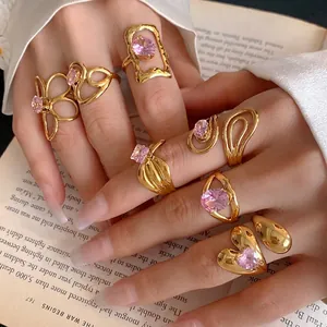 Luxury stainless steel rings with pink zircons in hollow flower and heart-shaped designs