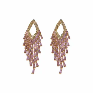 Sparkling pink zircon tassel earrings with gold rhombus design on white background