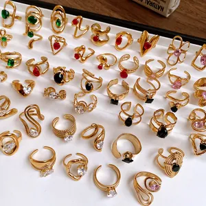 Detailed macro view of assorted gold stainless steel rings with vibrant zircon stones