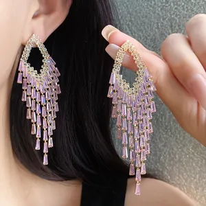 Detailed view of silver needle zircon fringe earrings with lavender crystal tassels