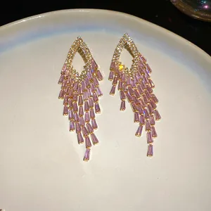 Detailed view of luxury pink crystal tassel earrings with sparkling cubic zirconia