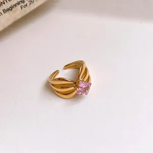 Detailed close-up of a gold stainless steel open ring with a pink zircon stone