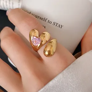 Close-up of a gold heart-shaped stainless steel ring with a pink zircon stone