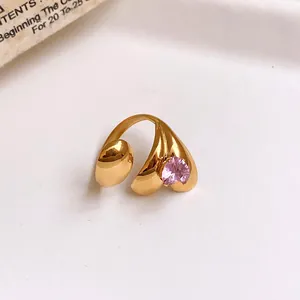 Close-up of a gold-plated flower ring with a pink heart-shaped zircon stone jewelry.
