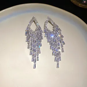 Detail shot of elegant clear zircon tassel earrings with sparkling diamond fringes