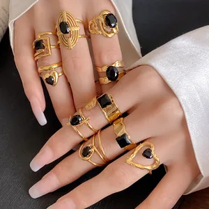 Close-up of vintage gold stainless steel rings with black zircon stones