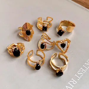 Detailed close-up view of elegant gold stainless steel rings featuring black zircon stones