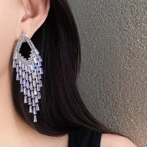 Close-up detail of luxury zircon tassel earrings with sparkling rhombus fringe design