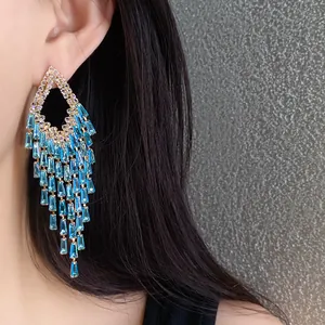 Close-up detail of heavy-duty silver needle zircon tassel earrings with blue crystals
