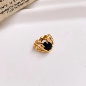 Detailed macro view of a gold stainless steel open ring featuring a large black zircon stone.