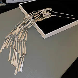 Close-up of a silver New Chinese style hair fork with flower and pearl tassel details