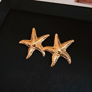 Elegant gold starfish stud earrings with crinkled metal texture and S925 silver needles