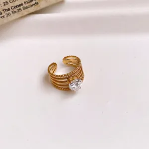 Detailed view of a gold-plated stainless steel hollow ring with a sparkling zircon