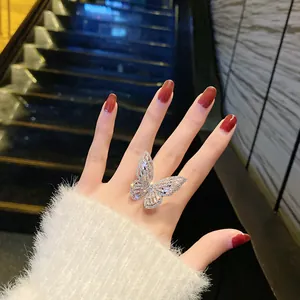 Detailed view of a luxurious sparkling zircon butterfly adjustable ring on a hand