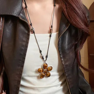 Vintage flower pendant necklace featuring tiger eye stones with a black leather cord