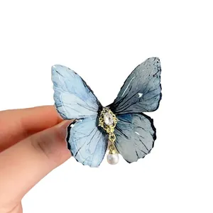 Elegant blue butterfly hair clip with shimmering pearl and rhinestone details for women