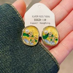 Detailed view of handmade enamel flower earrings featuring pearls and S925 silver needles