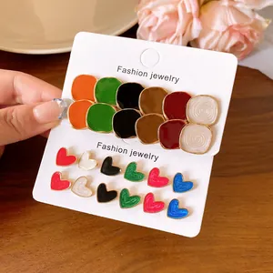 Macro view of colorful enamel stud earring set in varied round and heart-shaped designs