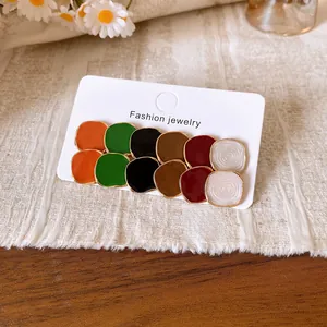 Detailed view of 12-piece colorful round enamel stud earrings set on a display card